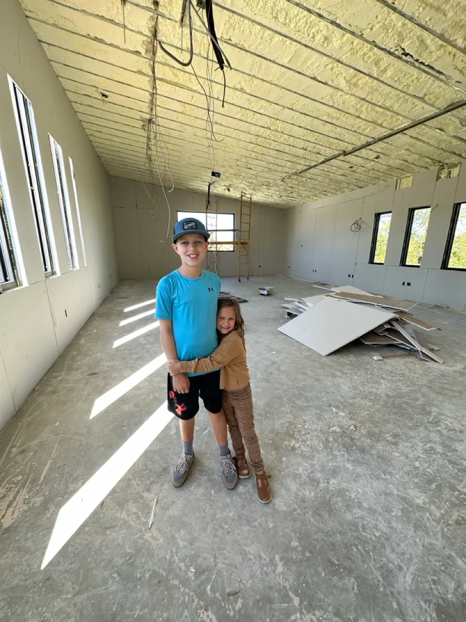 Our kids in the empty second floor, before the offices and desks.